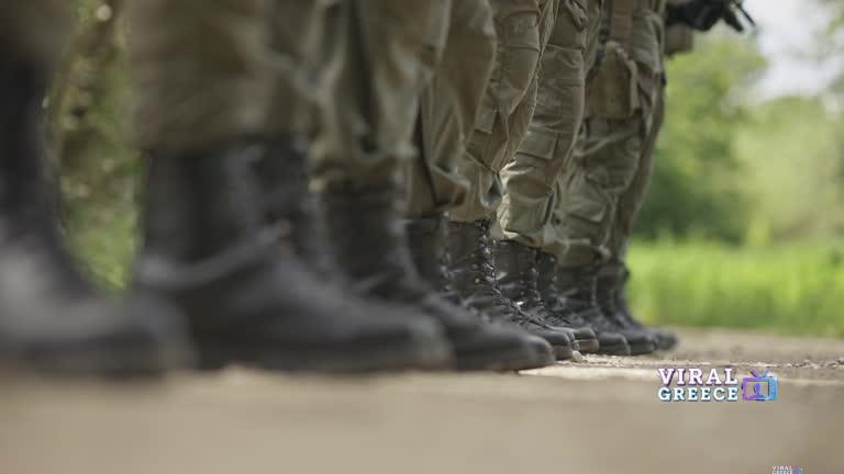 Army soldiers stand in formation. A close-up boots soldiers stock video